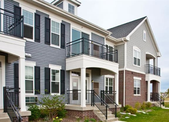 a row of houses with steps and balconies