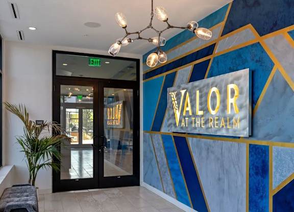 a lobby with a sign for aalor at the regal hotel