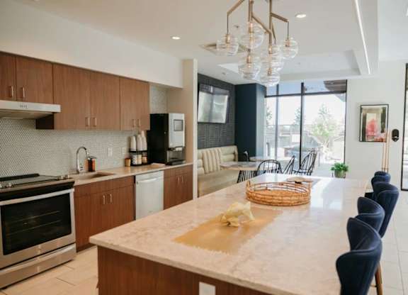 a kitchen and dining room with a marble counter top