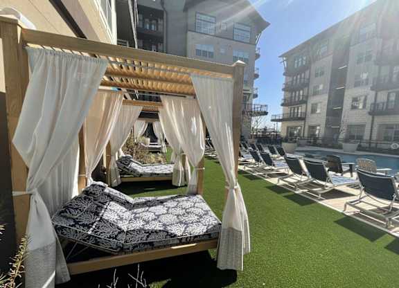 a bedroom with a canopy bed next to a pool