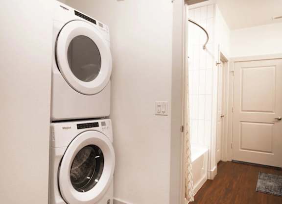 a washer and dryer in a white laundry room