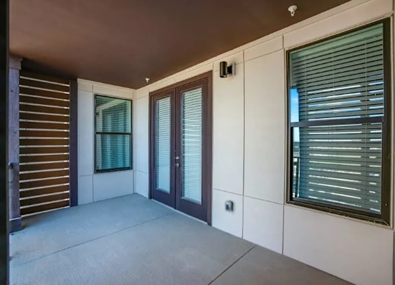 the living room of a house with windows and a patio