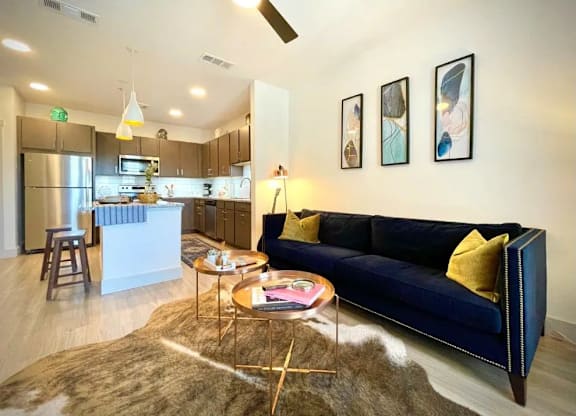 a living room and kitchen with a couch and a table