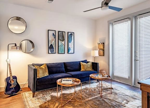 a living room with a couch and a guitar in it