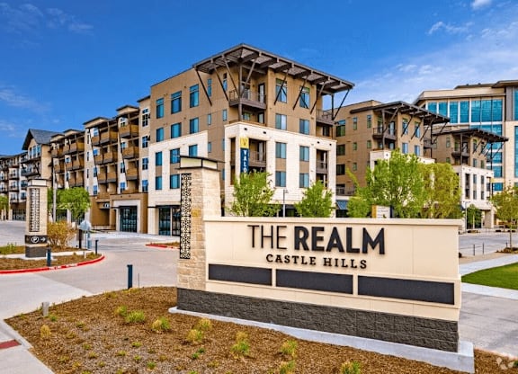 a building with a sign that says the realm casino hills in front of it