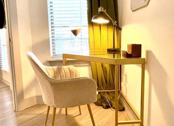 a chair and a desk in a room with a window