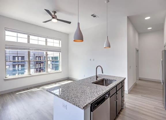 a kitchen with a granite counter top and a large window