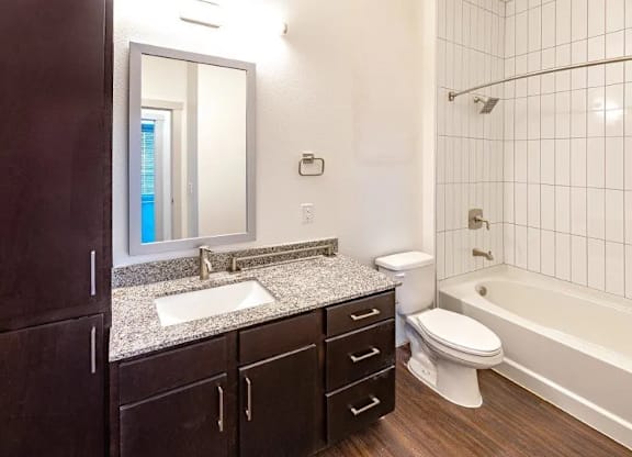 a bathroom with a sink toilet and a bath tub