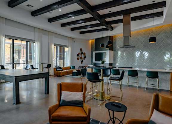 A modern dining room with a long table and chairs.