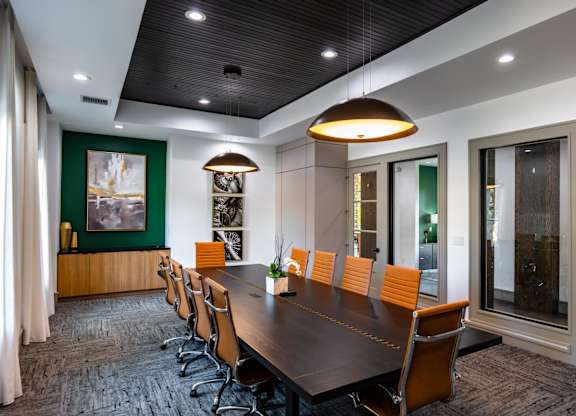 A conference room with a long table and chairs.