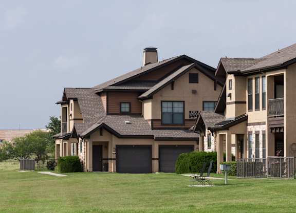 A large house with a brown roof and a garage door.
