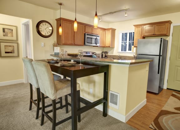 a kitchen with a large island with a breakfast bar