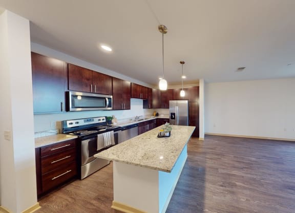 a kitchen with stainless steel appliances and a granite counter top