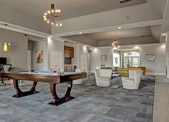 a games room with a shuffleboard table and couches