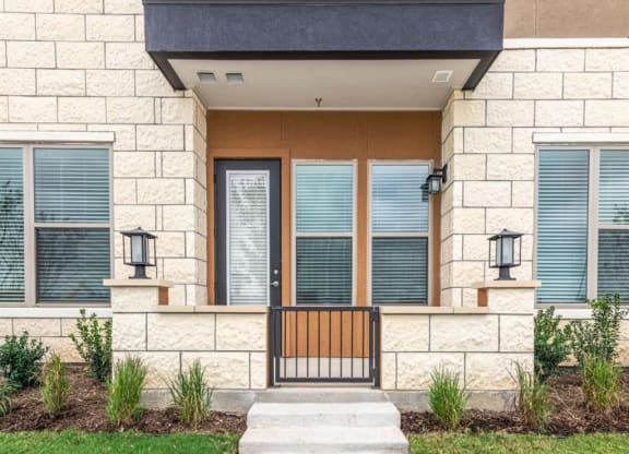 a house with a wooden door and a stone facade
