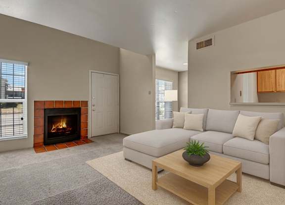 A cozy living room here at High Plains with soft beige carpet, a light-colored sectional sofa, and a warm fireplace with a tiled surround, complemented by a simple wooden coffee table, natural light from nearby windows, and an inviting, comfortable atmosphere.