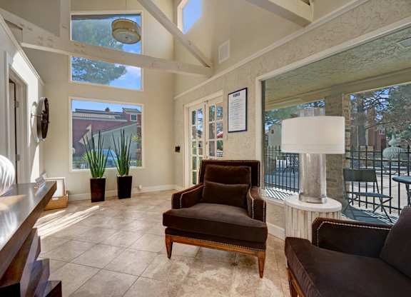 A living room with a brown chair and a white lamp.