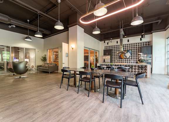 A modern dining room with a large table and chairs.