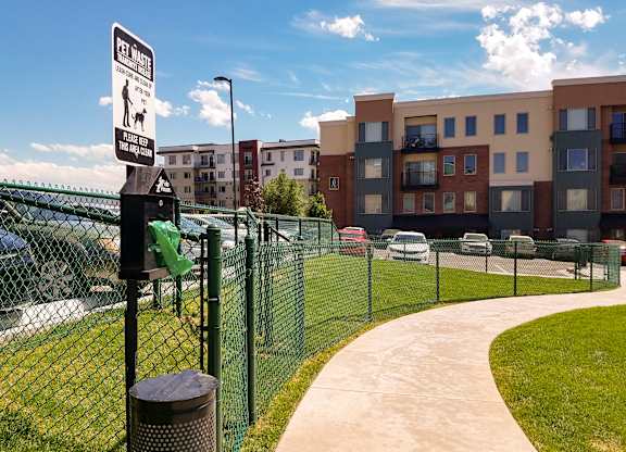A sign on a fence indicates that it is a pet waste zone.