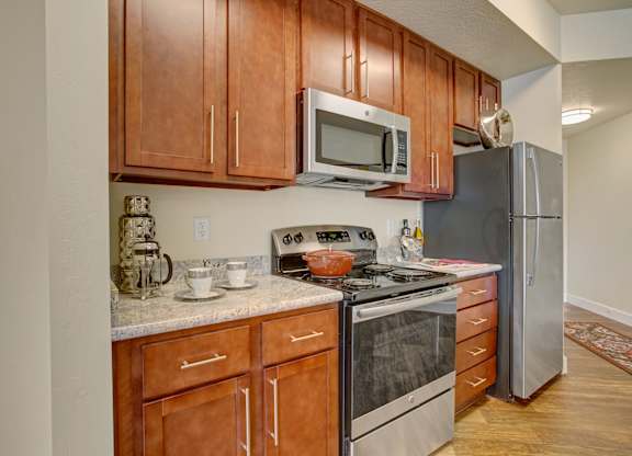 A kitchen with wooden cabinets and stainless steel appliances.