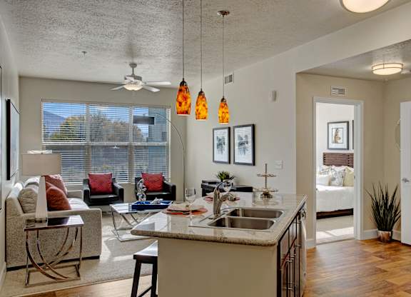 A kitchen with a white counter top and a sink.