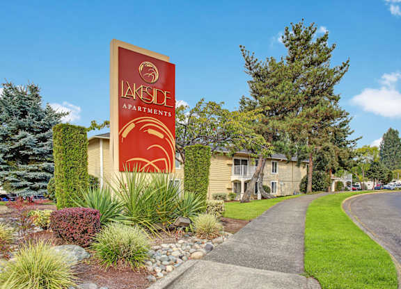 A sign for the Lakeside Apartments stands in front of the building.