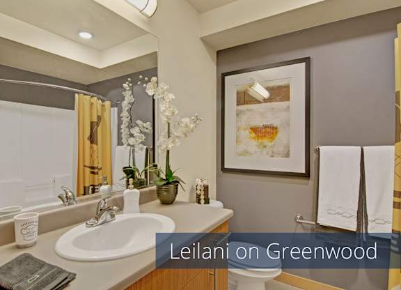 A convenient in-home laundry area here at Leilani on Greenwood featuring a stacked washer and dryer neatly tucked inside a dedicated closet. Wood-look doors provide a clean finish, while the compact layout offers easy access to laundry without leaving the apartment.