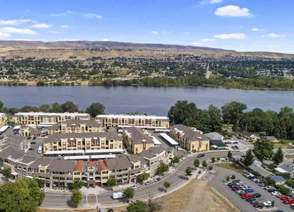 An aerial view here at Riverside 9 highlighting the community layout, riverfront location, and surrounding scenic mountain and neighborhood views.