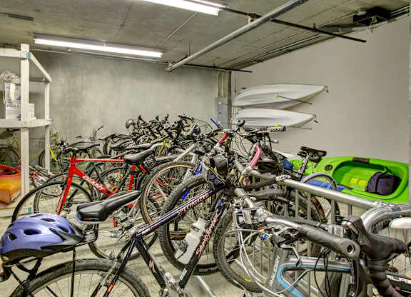 A bike helmet is on a bike in a parking garage.