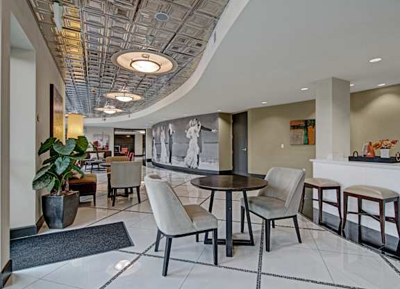 A modern dining room with a round table and chairs.