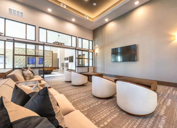 a living room with couches and chairs and a television