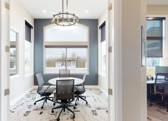 a dining room with a table and chairs and a chandelier