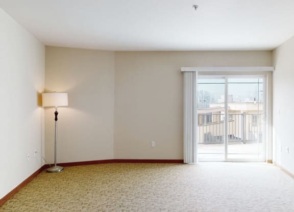 a bedroom with a sliding glass door and a lamp