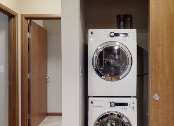 a front load washer and dryer in a laundry room