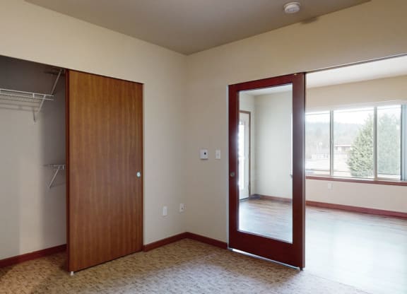 a bedroom with a closet and a window