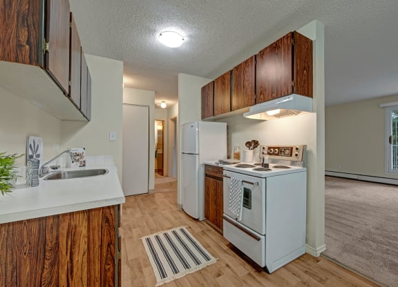 Cambridge West Kitchen Dark Cabinets White Appliances Apartments for rent in Edmonton, AB