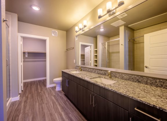 Harmony Luxury Apartments large bathroom with wooden floors
