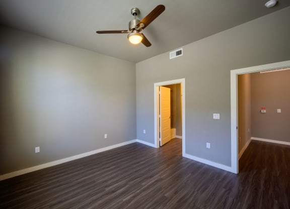 Harmony Luxury Apartments large bedroom with ceiling fan and tall ceilings