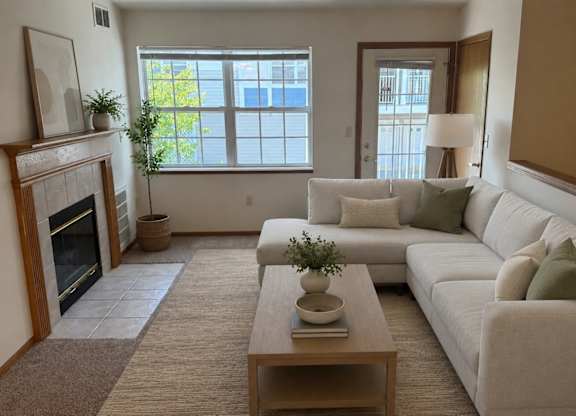 A living room with a fireplace and a couch.