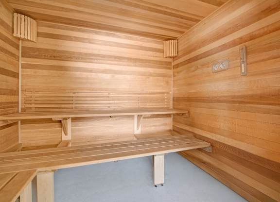 A relaxing sauna here at The Lafayette with warm wood paneling and tiered bench seating. A built-in thermometer and heater create a comfortable, spa-like space for unwinding.
