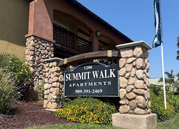 A sign for Summit Walk Apartments is in front of a building.