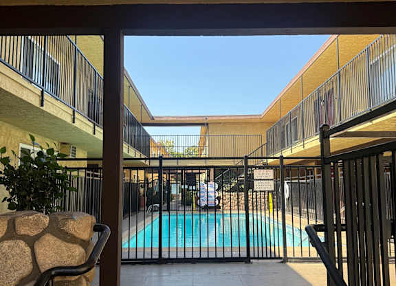 A pool is seen through a gate.