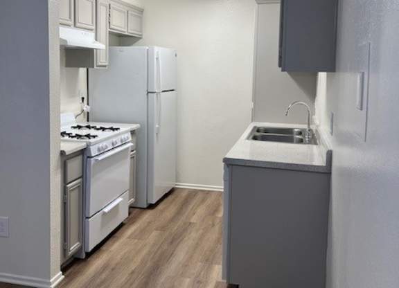 A small kitchen with a stove and a sink.
