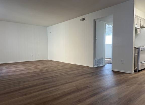A room with wooden floors and white walls.