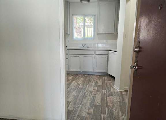 A kitchen with a sink and a window.