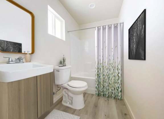 A bathroom with a toilet, sink, and shower.