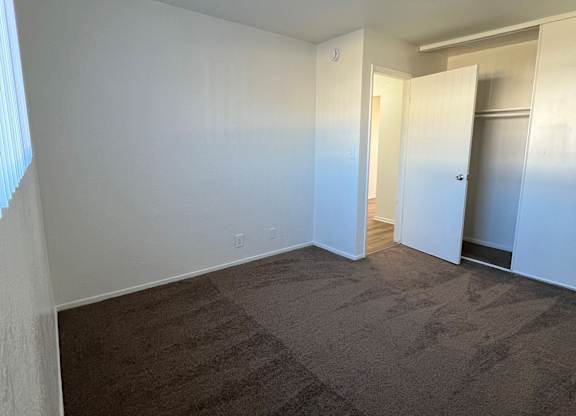 A room with a carpeted floor and white walls.
