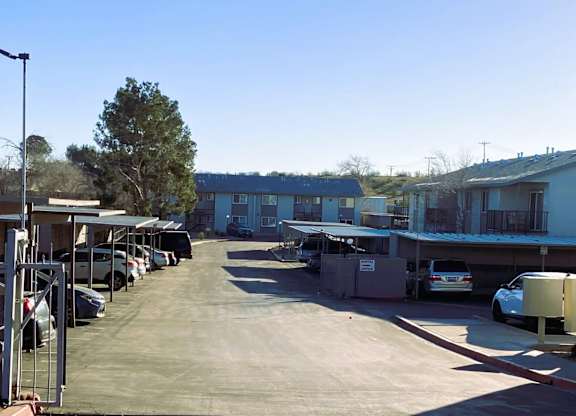 A parking lot with cars and a building in the background.