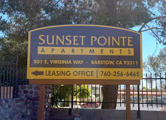 A sign for Sunset Pointe Apartments with a leasing office phone number.