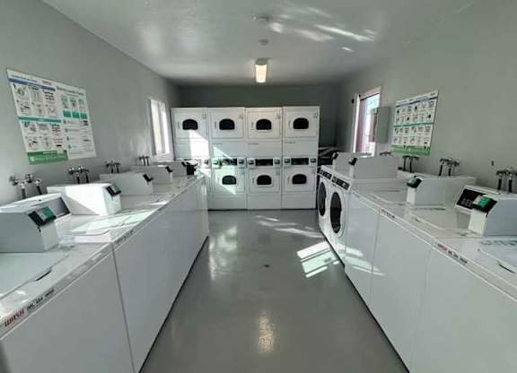A laundromat with rows of washers and dryers.